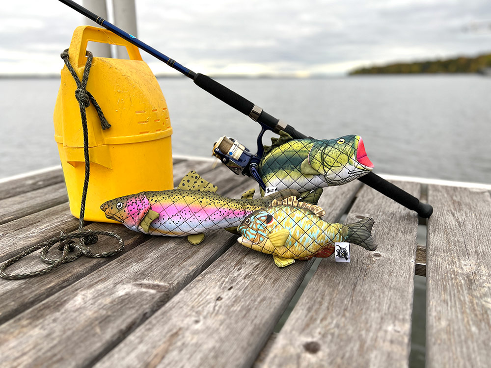 trio of fish dog toys on a dock